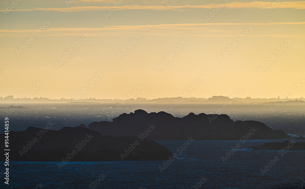 Fototapeta premium Sea haze in a rocky landscape at sunset.