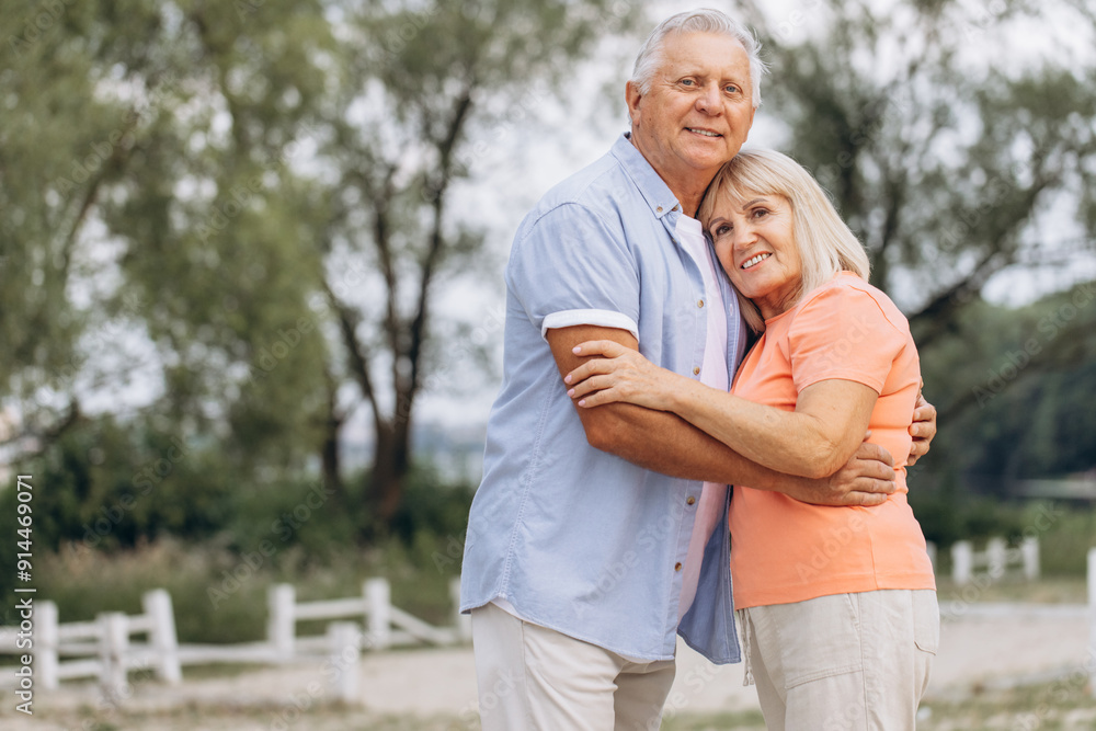 Happy Senior Couple Embracing Outdoors in Nature During a Summer Day Happy Senior Couple Embracing Outdoors in Nature During a Summer Day