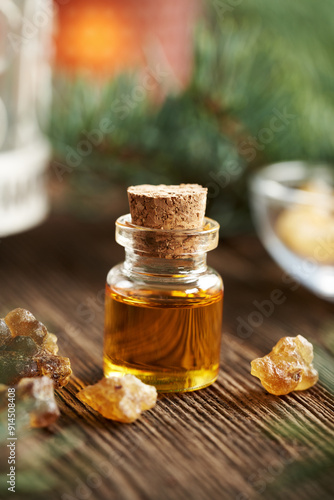 A bottle of frankincense essential oil with frankincense resin photo