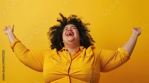 Isolated overweight plus size woman enjoying life on a plain yellow background. photo