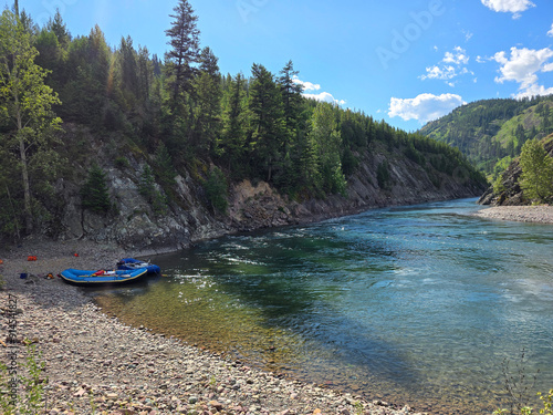 Rafts resting next to clear Montana stream