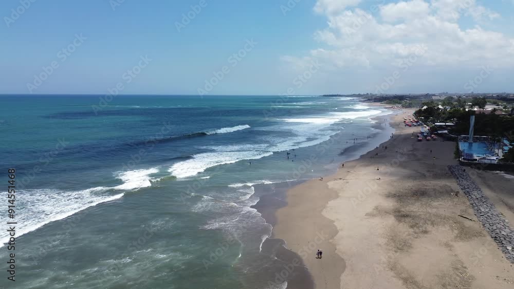 Berawa beach, aerial view of the beach on the coast of Bali, surfers in the water, tourists on the beach in Indonesia, view from a drone Berawa beach, aerial view of the beach on the coast of Bali, surfers in the water, tourists on the beach in Indonesia, view from a drone