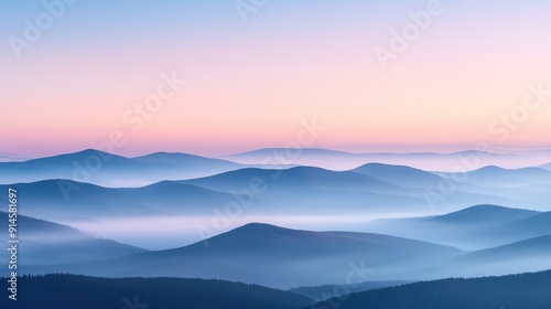 Serene Landscape of Foggy Mountain Range at Dawn with Soft Pastel Colors and Layered Peaks