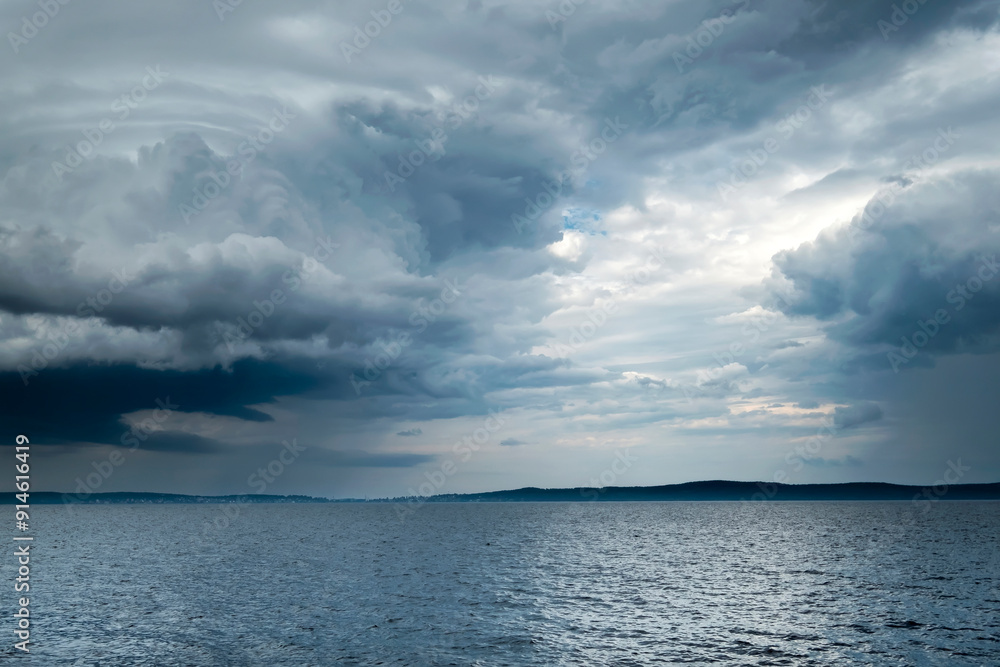 Obraz premium Cloudy rainy weather. Beautiful dark dramatic sky and lake.