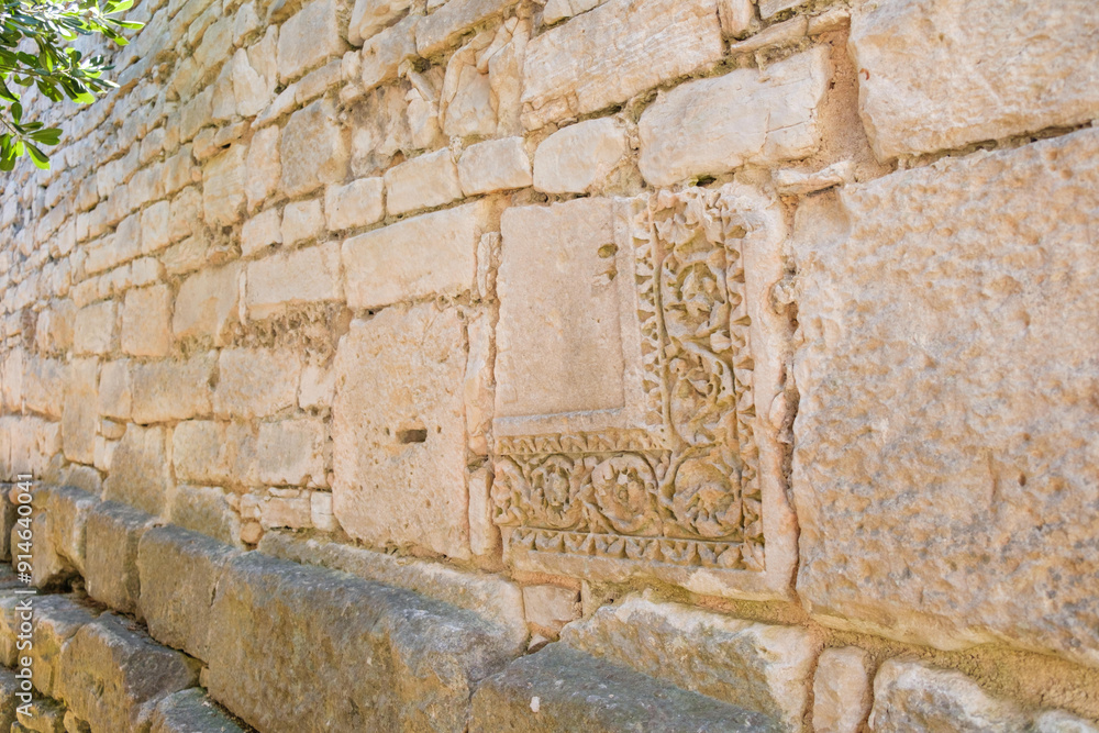 Remains of carved Roman stones, reused in the construction of modern walls. Remains of carved Roman stones, reused in the construction of modern walls.