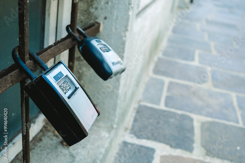 Security boxes for storing keys to tourist apartments, in the form of a padlock on the street.