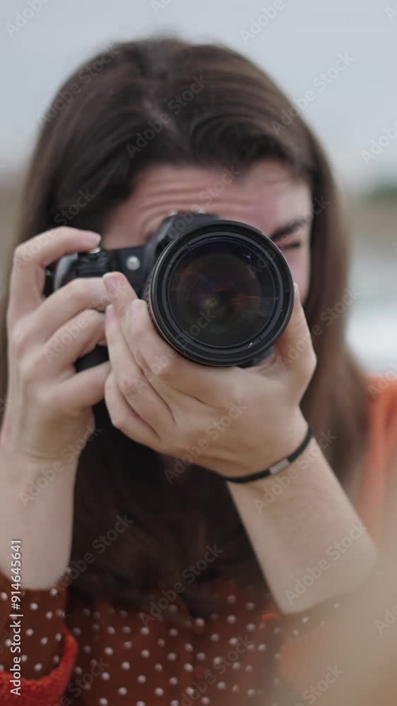 Photographer pointing lens at model with good angle Photographer pointing lens at model with good angle