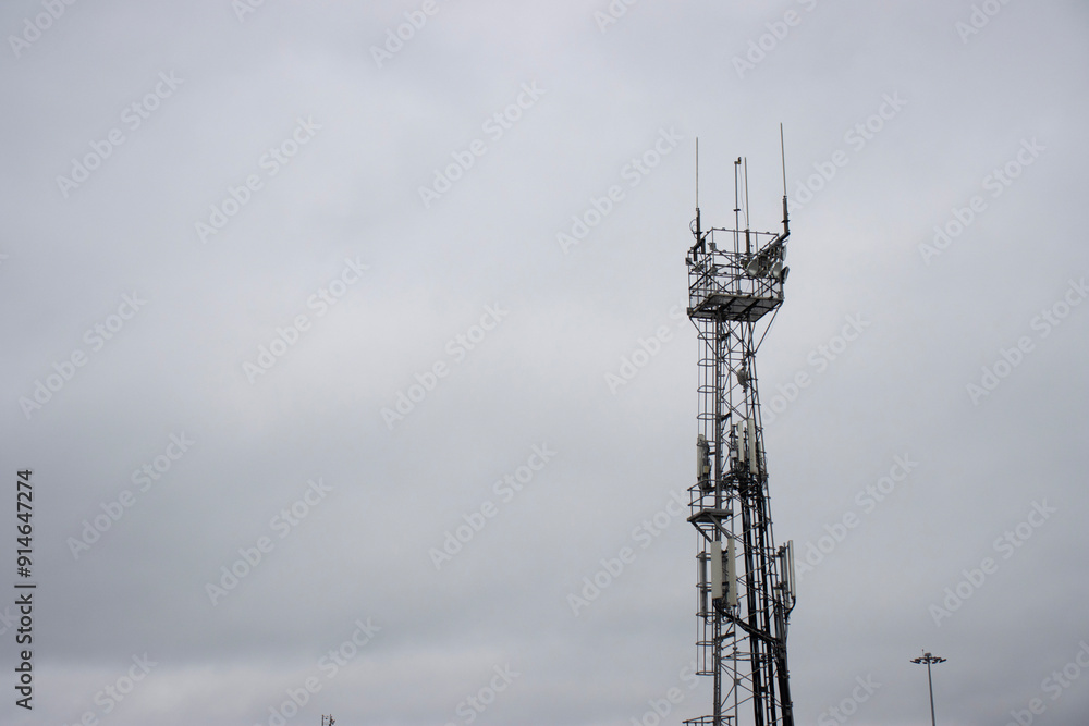 Communication tower against the sky. Electric and radio tower. Copy space Communication tower against the sky. Electric and radio tower. Copy space