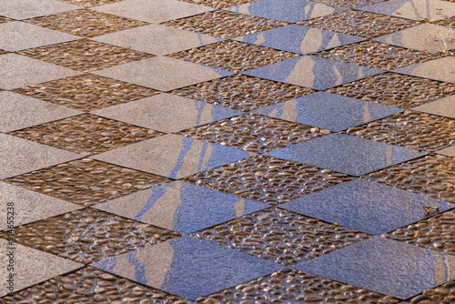 Obraz na płótnie Cut stone tiles and cobbles pave a plaza in Granada. w salonie