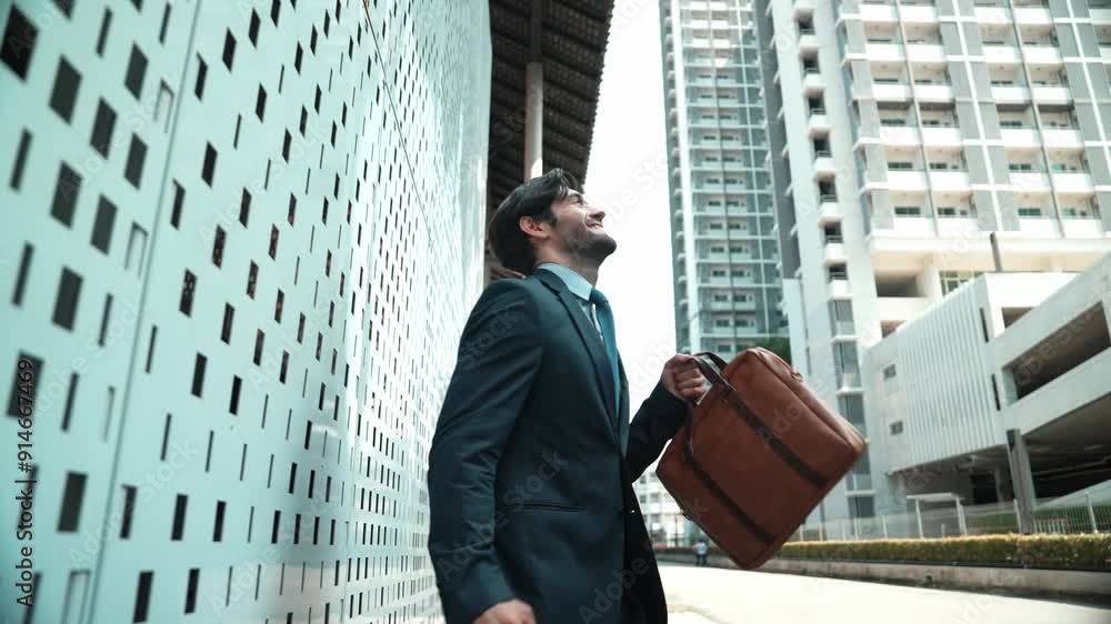 Skilled business man dancing with joyful while walking in city street. Project manager receive a good news, getting promotion, getting a successful job while express feeling of overjoy. Exultant. Skilled business man dancing with joyful while walking in city street. Project manager receive a good news, getting promotion, getting a successful job while express feeling of overjoy. Exultant.