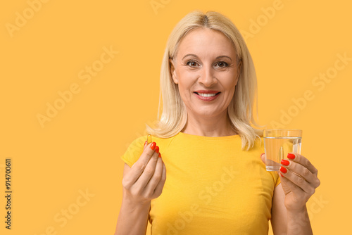 Mature woman taking fish oi...