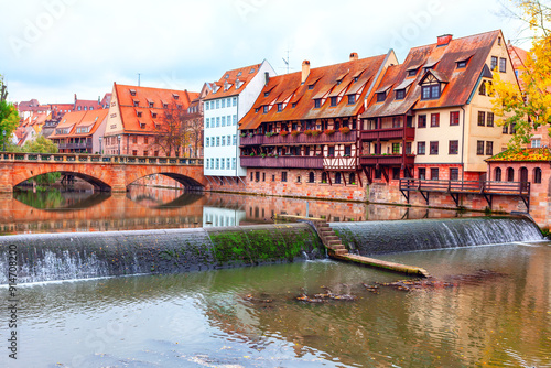 Picturesque river flows through an urban landscape in Nuremberg in Germany, showcasing the harmony between nature and city architecture photo