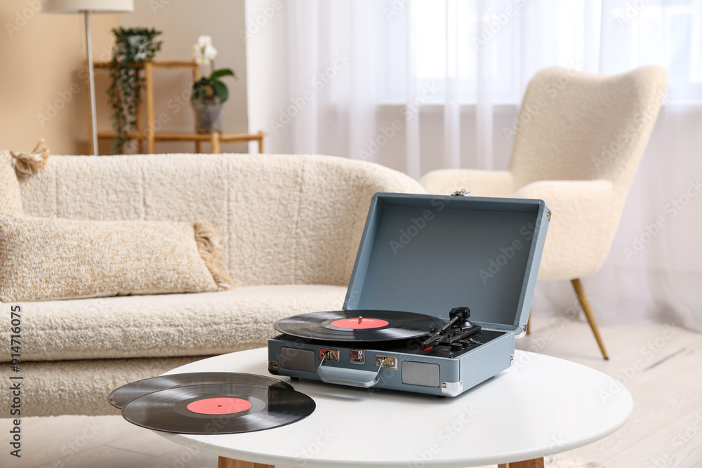 Record player with disks on coffee table in room Record player with disks on coffee table in room