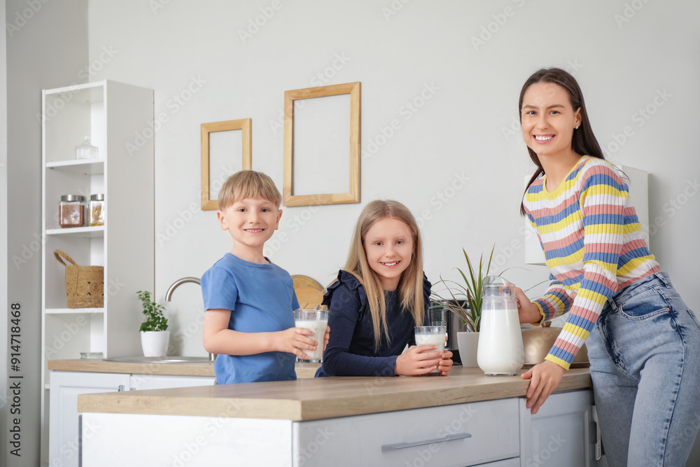 Happy family drinking milk at counter in kitchen Happy family drinking milk at counter in kitchen