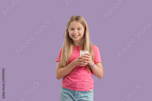 Little girl with glass of m...