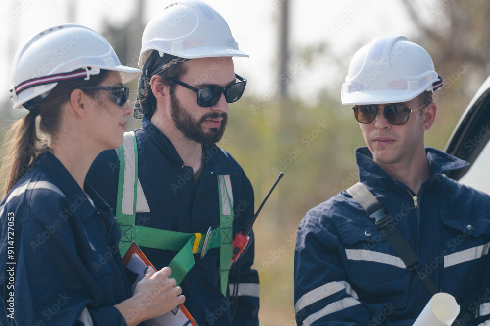 A team of engineers sitting in a van is inspecting the construction of a wind turbine and surrounding structures in a remote area to produce clean electricity. A team of engineers sitting in a van is inspecting the construction of a wind turbine and surrounding structures in a remote area to produce clean electricity.