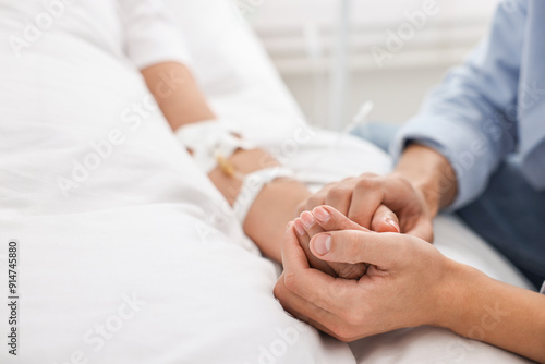 Obraz na plátně Coma patient. Man near unconscious woman in hospital, closeup