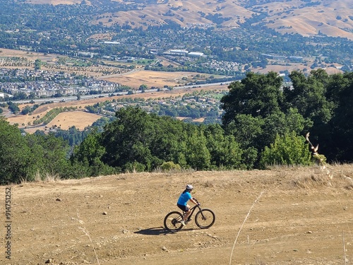 Photography A mountain biker rides on the Pleasanton Ridge trail with views of the San Ramon