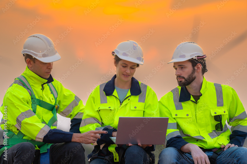 Team Engineers men and woman checking and inspecting on construction with sunset sky. people operation. Wind turbine for electrical of clean energy and environment. Industrial of sustainable. Team Engineers men and woman checking and inspecting on construction with sunset sky. people operation. Wind turbine for electrical of clean energy and environment. Industrial of sustainable.