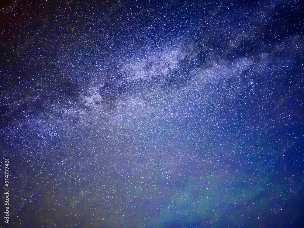 Photograph captures the breathtaking beauty of a starry night sky. The Milky Way stretches across the frame like a cosmic river, with stars twinkling against the deep, inky darkness of the universe. Photograph captures the breathtaking beauty of a starry night sky. The Milky Way stretches across the frame like a cosmic river, with stars twinkling against the deep, inky darkness of the universe.