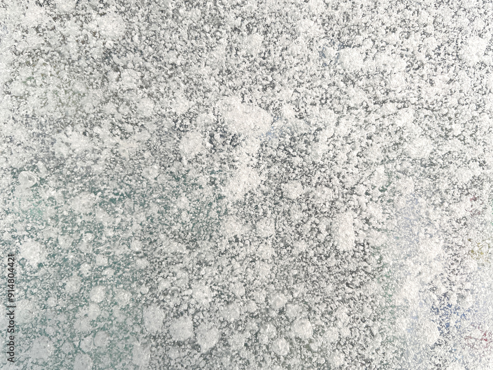 Ice texture background. Textured cold frosty surface of ice block with frozen air bubbles. Ice texture background. Textured cold frosty surface of ice block with frozen air bubbles.