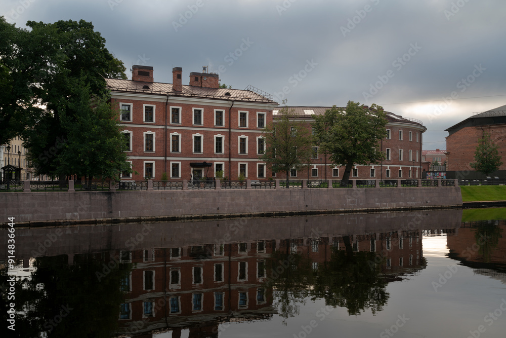 View of the brick buildings, formerly the commandant's house and the prison building, on the island of New Holland on the banks of the Moika River on a sunny day, St. Petersburg, Russia View of the brick buildings, formerly the commandant's house and the prison building, on the island of New Holland on the banks of the Moika River on a sunny day, St. Petersburg, Russia