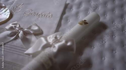 Elegant baptism set with personalized towel, seashell, candle, and delicate ribbons photo