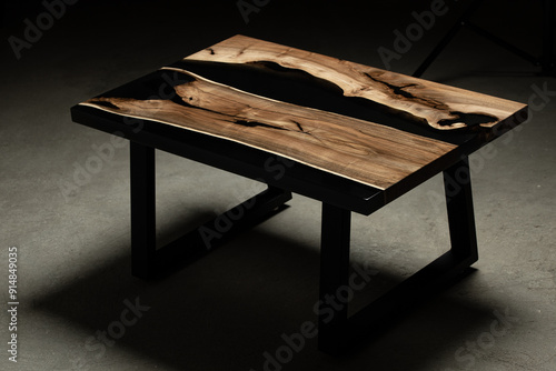 Expensive vintage furniture. The table is covered with epoxy resin and varnished. Luxury quality wood processing. Wooden table on a dark background. Black river made of epoxy resin.