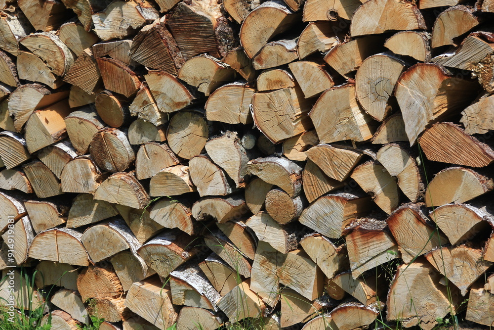 Cut firewood stacked outside. Background of wooden logs Cut firewood stacked outside. Background of wooden logs