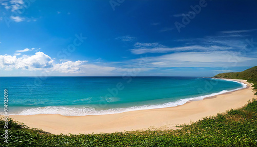 The wide sea and the sandy beach. Blue sky.