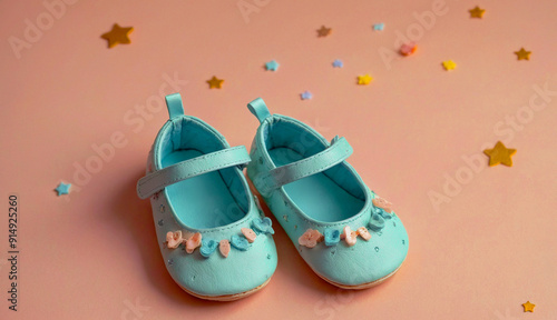 Blue Baby Shoes with Floral Accents on Pastel Background photo