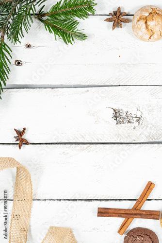 Festive Rustic Background with Natural Christmas Decorations. A flat lay of a rustic Christmas-themed background on white wooden planks, featuring a mix of natural decorations such as pine cones, cinn photo