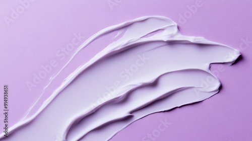 Smear of purple cream on lilac background