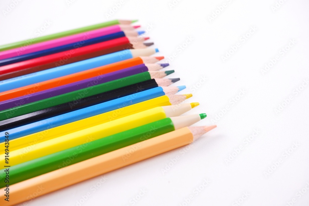 Wooden colored pencils and paper isolated on white backdrop with copy space image. Wooden colored pencils and paper isolated on white backdrop with copy space image.