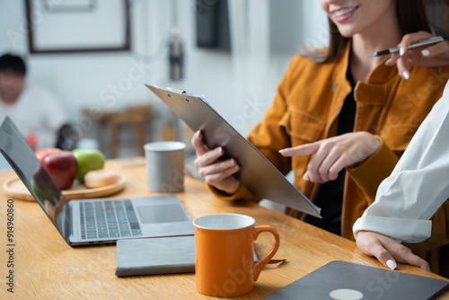 Woman uses laptop to work in the kitchen