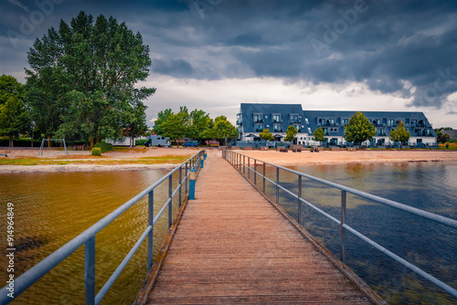 Tableau sur toile Gloomy summer cityscape of Dranske villige with old wooden pier, Germany, Europe
