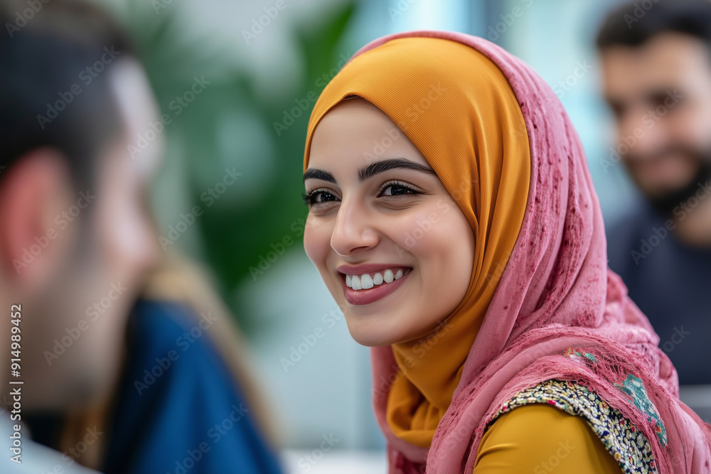 woman wearing a pink scarf and a yellow head scarf is smiling. She is surrounded by other people, but the focus is on her. Concept of warmth and happiness, as the woman's smile is contagious woman wearing a pink scarf and a yellow head scarf is smiling. She is surrounded by other people, but the focus is on her. Concept of warmth and happiness, as the woman's smile is contagious