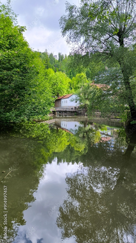 landscape by the Pivka river in spring in Postojna village, Slovenia landscape by the Pivka river in spring in Postojna village, Slovenia