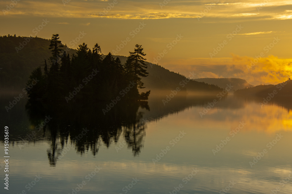 Fototapeta premium Sunset over a magnificent fishing lake in the Canadian forest