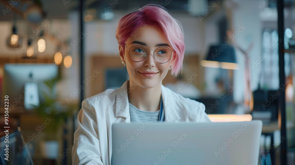 A beautiful professional woman uses a laptop in a modern office A beautiful professional woman uses a laptop in a modern office