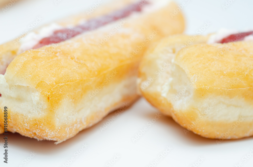 A jelly donut with a jelly filling and a powdered sugar topping A jelly donut with a jelly filling and a powdered sugar topping