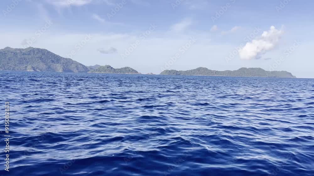 Seascape from moving boat on a sunny day. Beautiful skyscape. Vacation, travel, and holiday concept. Seascape from moving boat on a sunny day. Beautiful skyscape. Vacation, travel, and holiday concept.