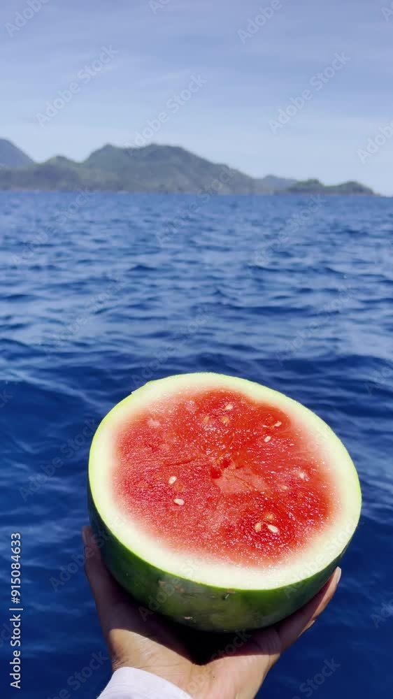The angler is resting while eating watermelon. Vacation, travel, and holiday concept. The angler is resting while eating watermelon. Vacation, travel, and holiday concept.