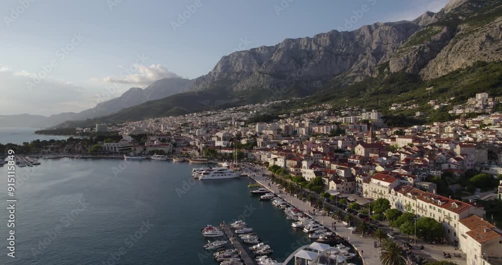 Beautiful Makarska In Croatia At Sunset. Cruise Ship And Luxury Yachts Docked At Harbor. Beautiful Makarska In Croatia At Sunset. Cruise Ship And Luxury Yachts Docked At Harbor.