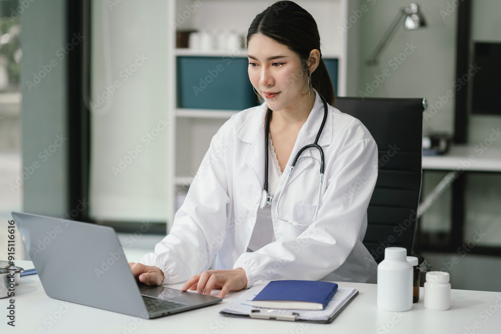 Doctor working on laptop computer and tablet and medical stethoscope on clipboard on desk, electronics medical record system EMRs concept. Doctor working on laptop computer and tablet and medical stethoscope on clipboard on desk, electronics medical record system EMRs concept.