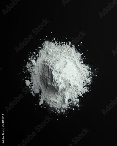 a close up of a pile of white powder on a black surface.