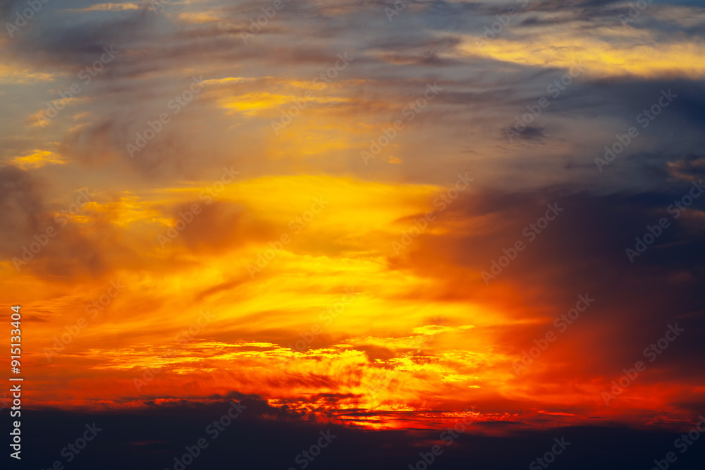 Beautiful sunset with a warm orange and yellow sky. The clouds are scattered throughout the sky, creating a sense of depth and movement. The colors of the sky are vibrant and calming Beautiful sunset with a warm orange and yellow sky. The clouds are scattered throughout the sky, creating a sense of depth and movement. The colors of the sky are vibrant and calming