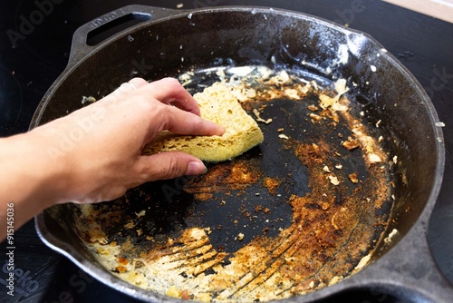 une poêle sale et la ville qui la lave avec une éponge