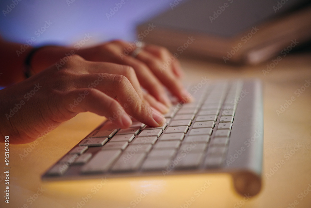 Close-up view of hands typing on keyboard with focused movements creating an intense and productive atmosphere suitable for various work environments Close-up view of hands typing on keyboard with focused movements creating an intense and productive atmosphere suitable for various work environments