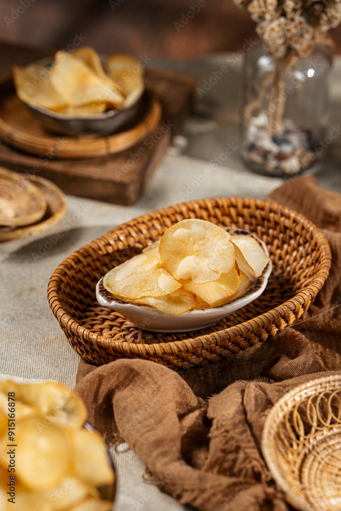 Cassava chips, a traditional Indonesian snack, are made from thin slices of cassava and then dry fried sprinkled with salt Cassava chips, a traditional Indonesian snack, are made from thin slices of cassava and then dry fried sprinkled with salt